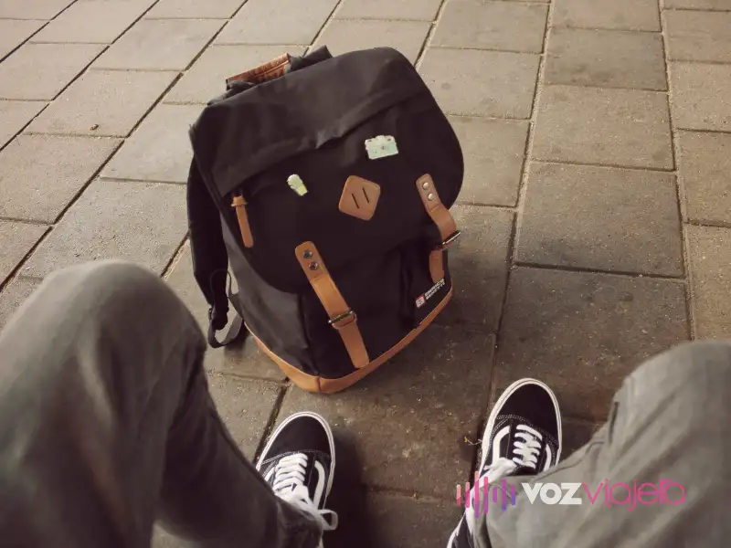 Man looking at his luggage backpack.