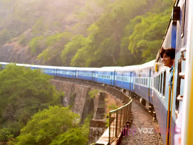 Woman leaning out of the window of a train traveling in Europe