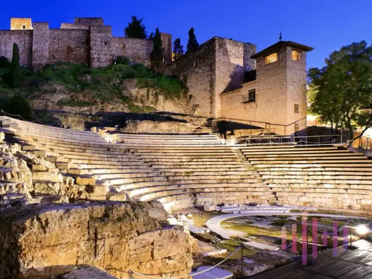 Roman Theatre of Malaga illuminated at night.