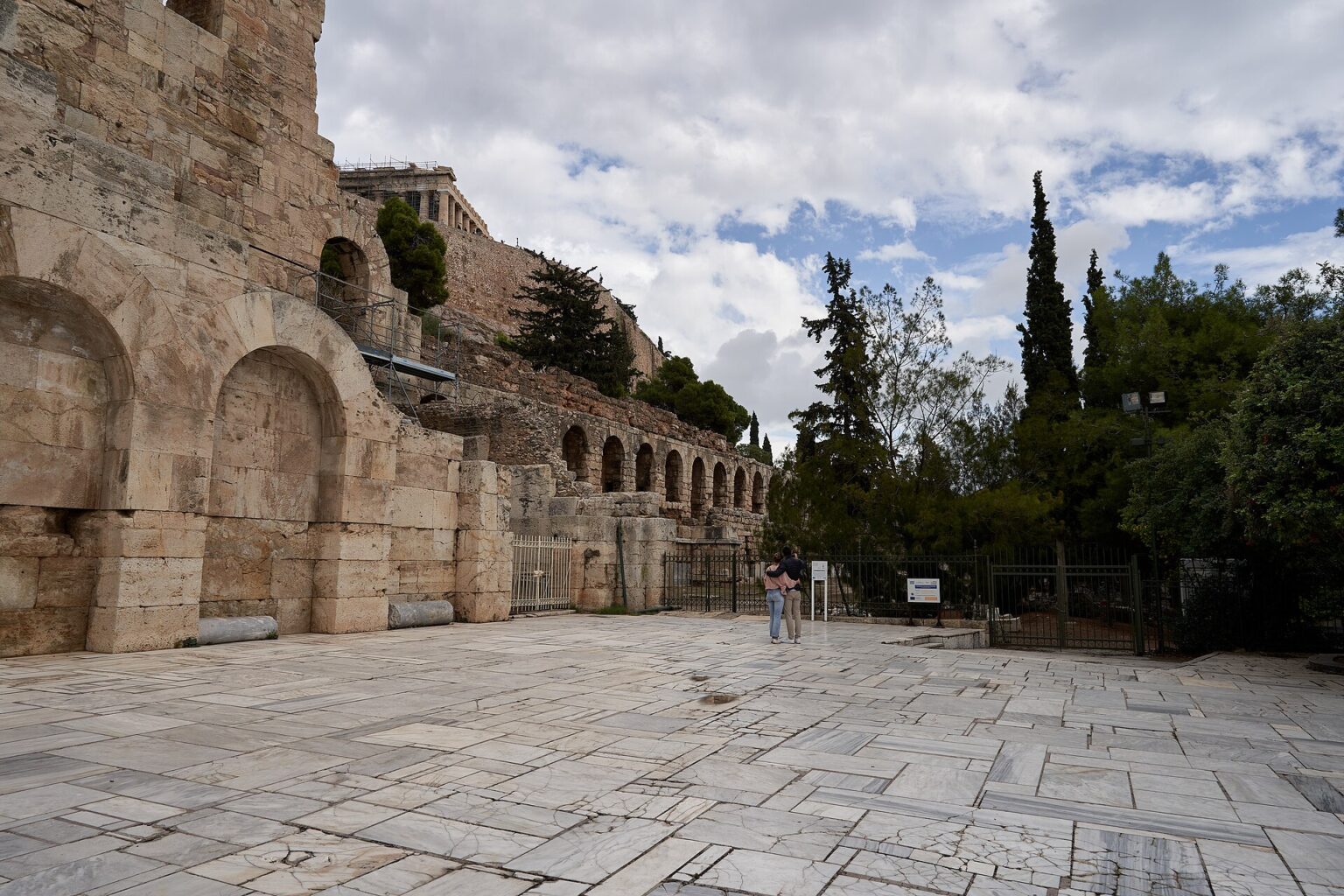 The Odeon of Herodes Atticus from the esplanade of the South Slope, with the arches of the Stoa of Eumenes running east along the hillside and the Acropolis above