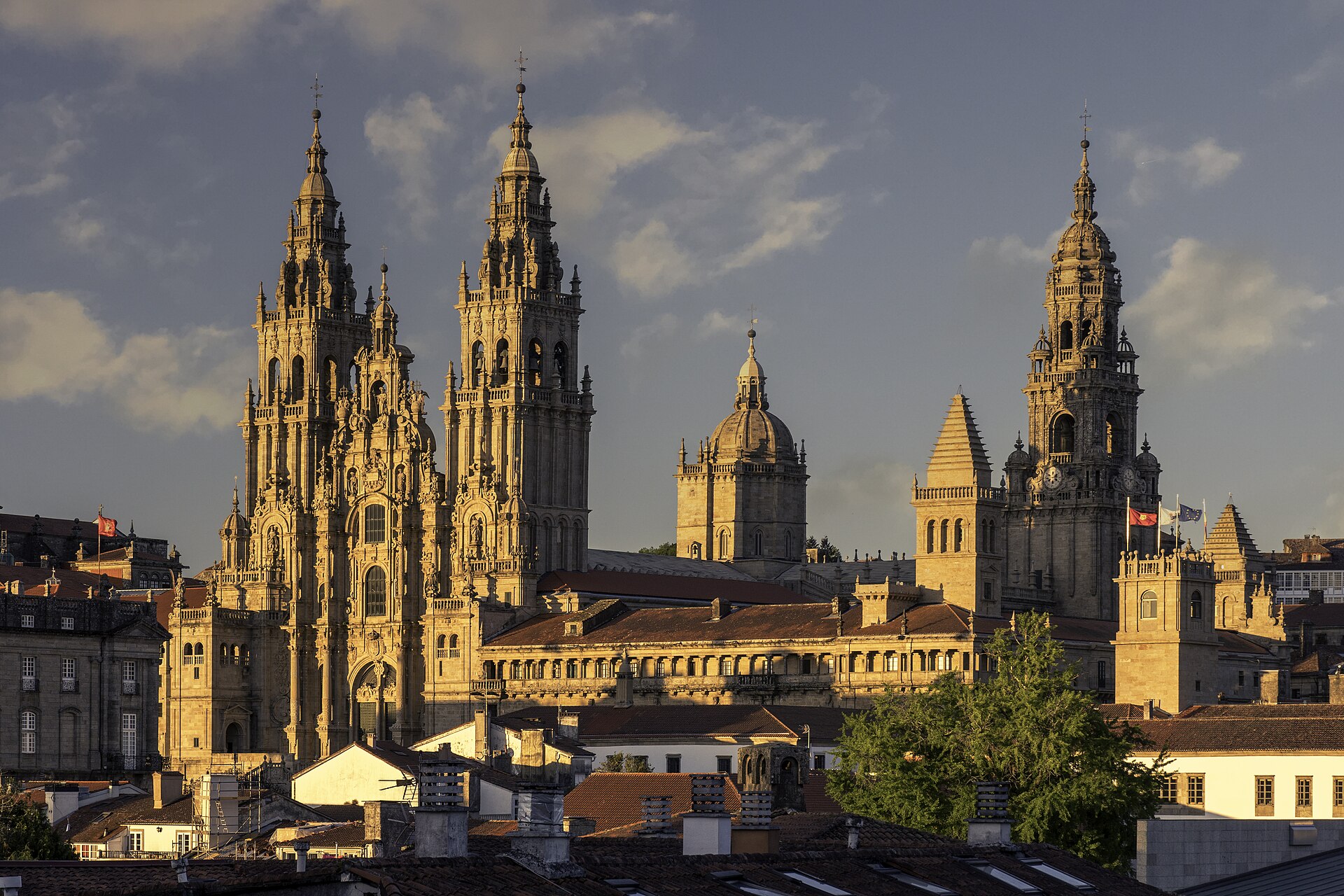 Santiago de Compostela Cathedral seen from Alameda Park in the evening light: the baroque Obradoiro towers and the dome rising above the old town roofs