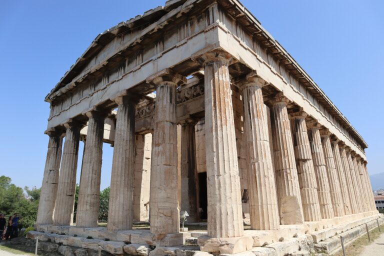 The Temple of Hephaestus in Athens seen from one corner, with its triangular pediment, the Doric columns of the front and the whole row down the flank, and the entablature and part of the roof still in place