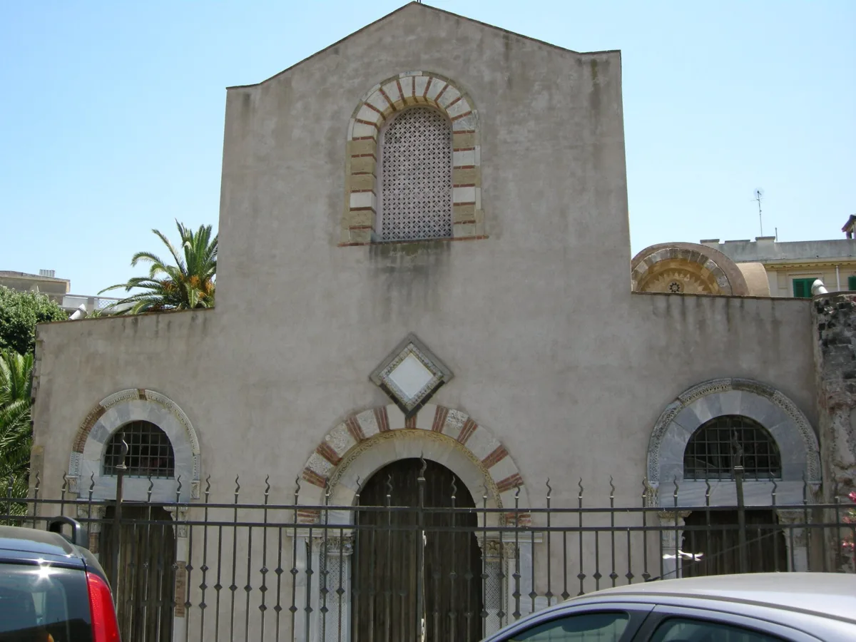 The west front of the Church of the Santissima Annunziata dei Catalani in Messina, with its 3 doorways behind the railings