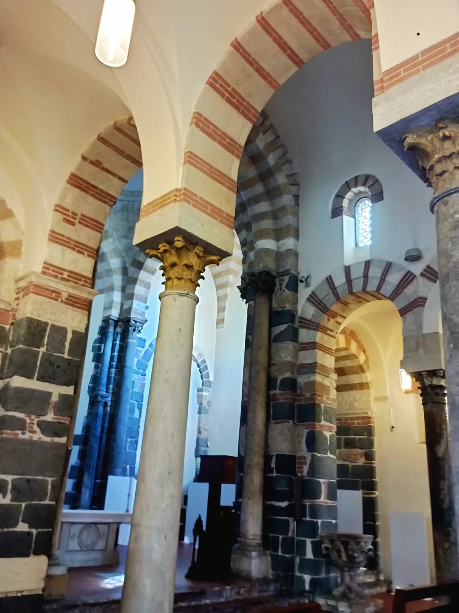 Inside the Church of the Catalans in Messina: two-tone striped arches resting on columns