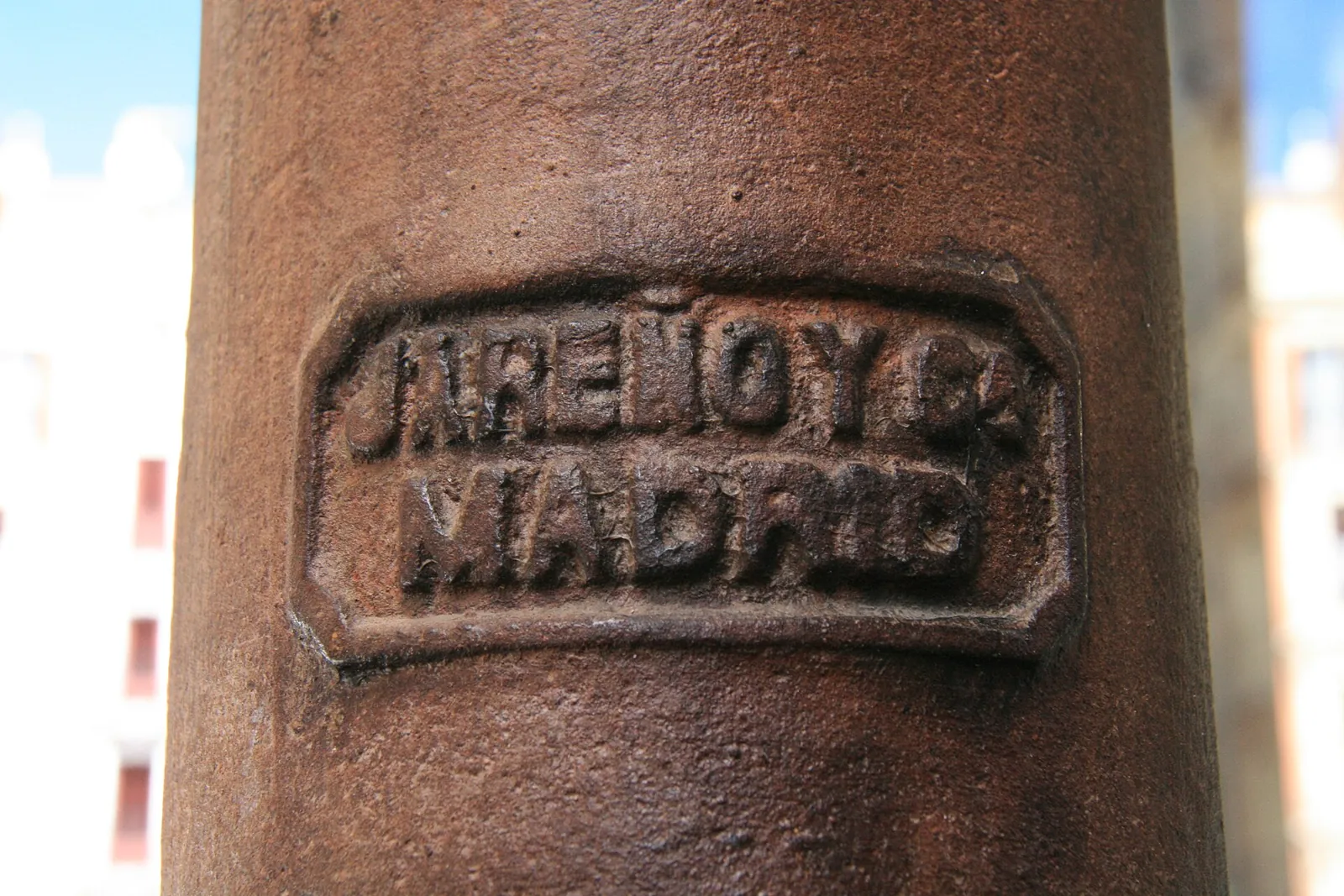 Close-up of a cast-iron column at the Mercado de San Miguel with the raised maker's mark J. Jareño y C.ª Madrid