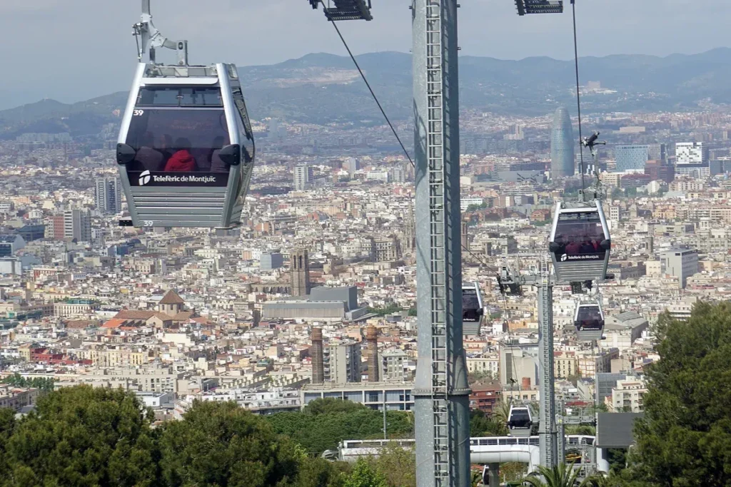 Cabins of the Montjuïc cable car on their cable above the rooftops of Barcelona
