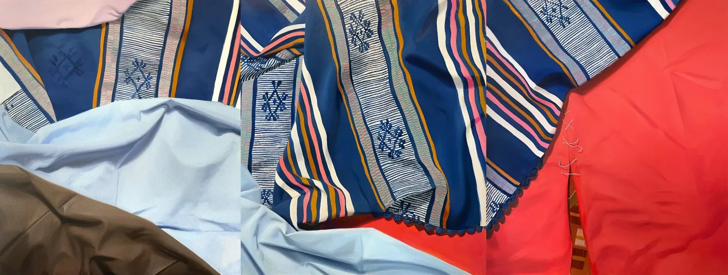 Detail of Fardo by Andrea Canepa: overlapping painted fabrics in navy blue with striped bands, light blue, red and brown