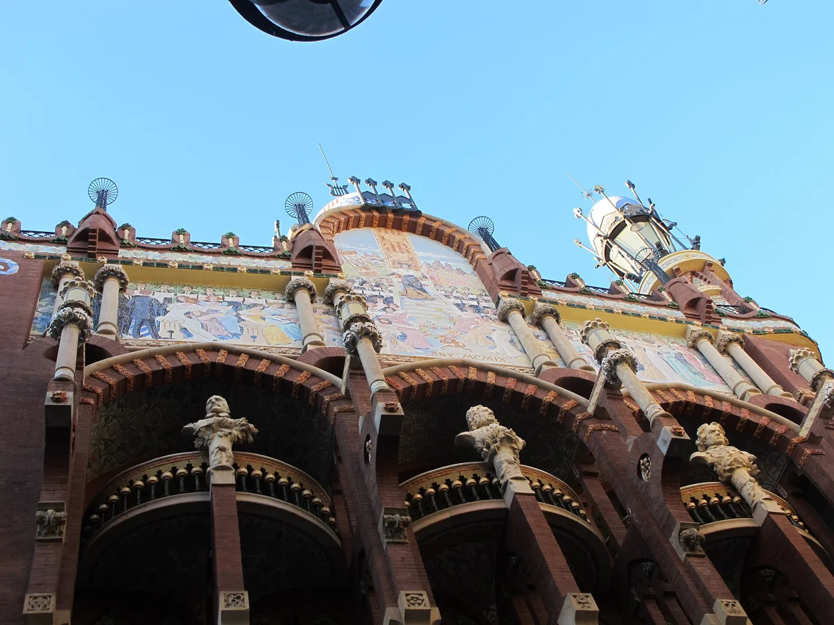 The top of the old façade of the Palau de la Música Catalana, with the mosaic pediment and busts of composers on the columns