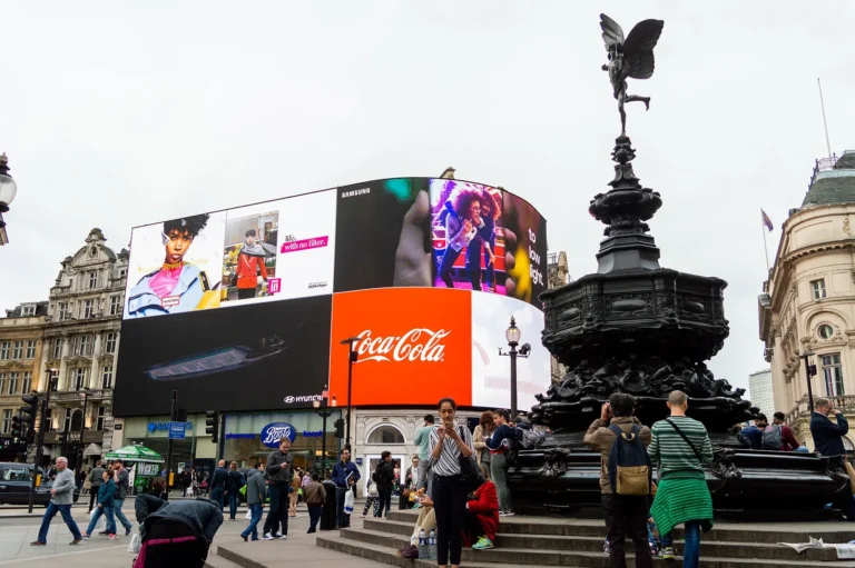 The Shaftesbury Memorial fountain with its winged figure on top and, behind it, the huge curved Piccadilly Lights screen showing adverts