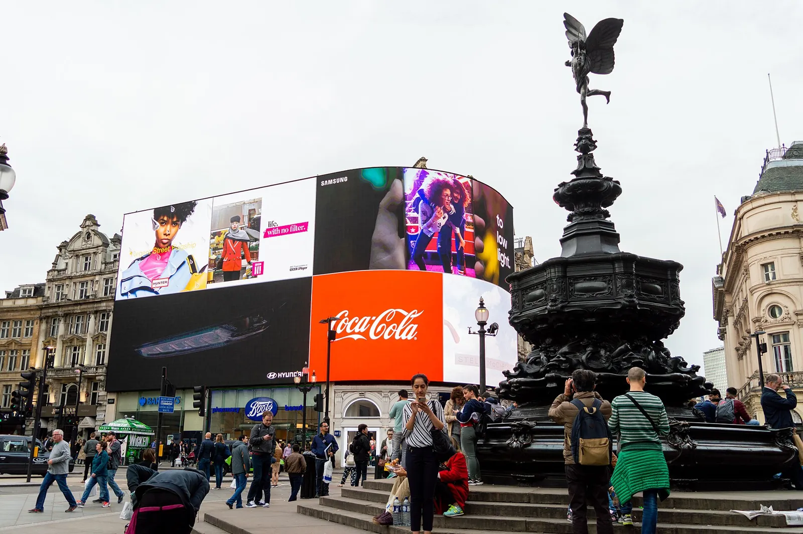 The Shaftesbury Memorial fountain with its winged figure on top and, behind it, the huge curved Piccadilly Lights screen showing adverts
