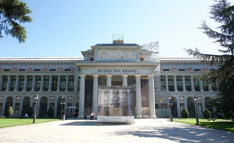 Main façade of the Prado Museum's Villanueva building, with the columned portico of the Velázquez door, the MUSEO DEL PRADO lettering and scaffolding in front