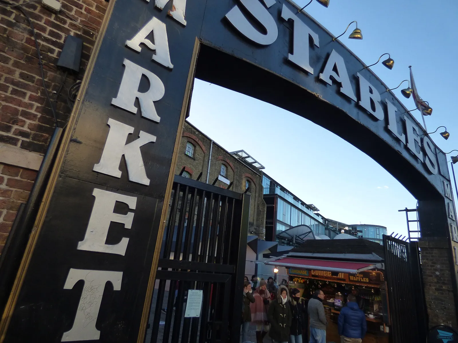 Iron arch with the Stables Market sign at the entrance from Chalk Farm Road