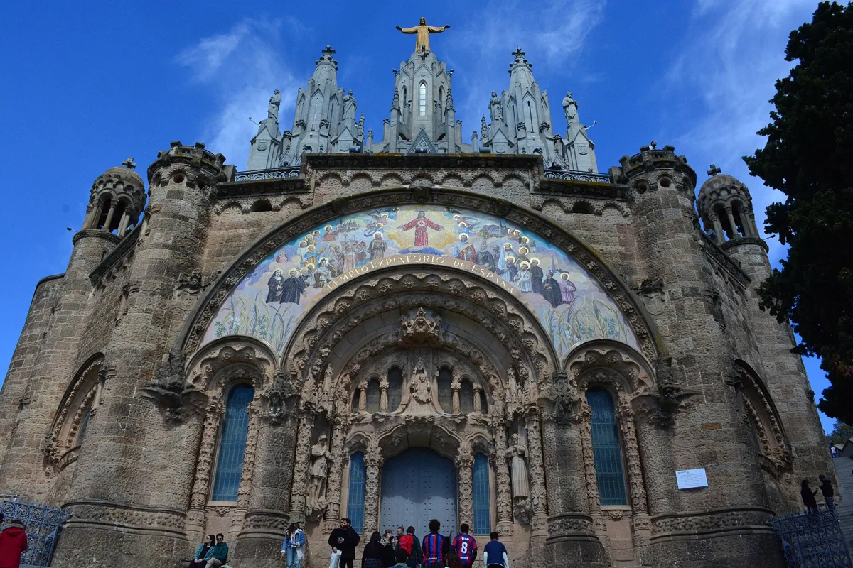 The front of the Temple of the Sacred Heart on Tibidabo: the stone crypt with a large mosaic over the entrance arch and the towers of the upper church above