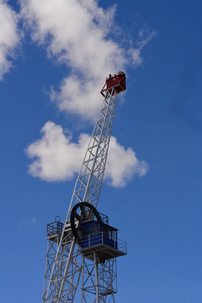 The Talaia at Tibidabo, a tall metal mast with a red viewing cabin at the top, against a blue sky