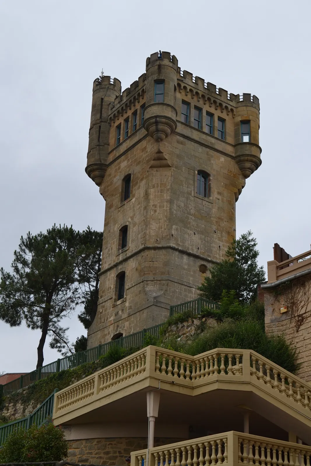 The stone tower on Monte Igueldo, with battlements and corner turrets, above a terrace with a balustrade
