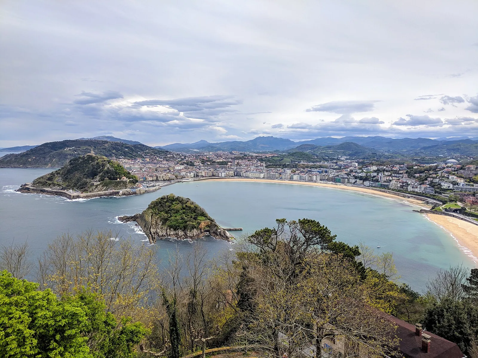 View of San Sebastián from Monte Igueldo: La Concha bay with Santa Clara Island in the middle, Mount Urgull behind it and the beach on the right