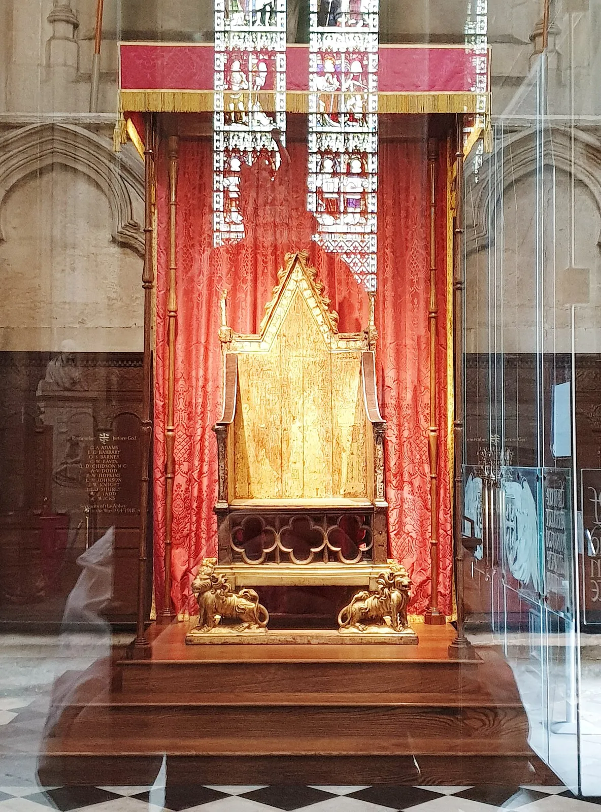 The Coronation Chair in Westminster Abbey, a wooden throne with traces of gilding and gilt lions at its base